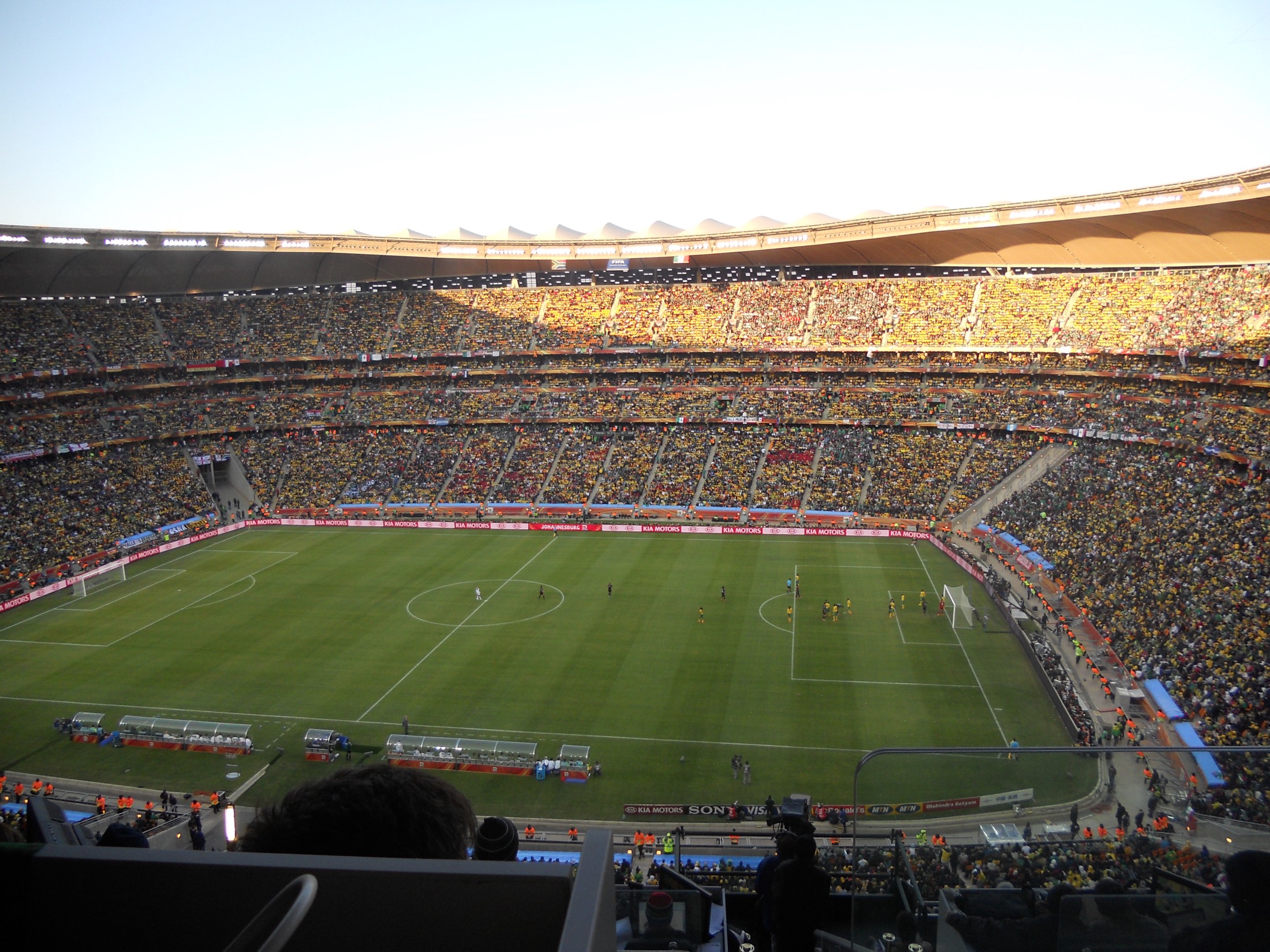 A packed stadium under a clear sky before a match